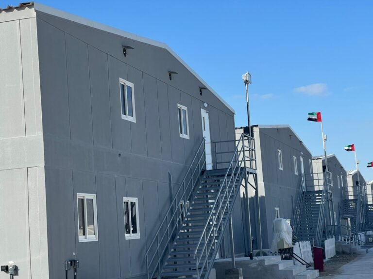 Two-story prefabricated modular labor accommodation units with external steel staircases, manufactured by Southend Prefab in Sharjah, UAE.